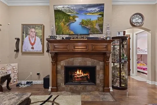 a living room with painting on the wall and a fireplace