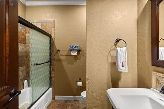 a bathroom with a sink vanity mirror and toilet