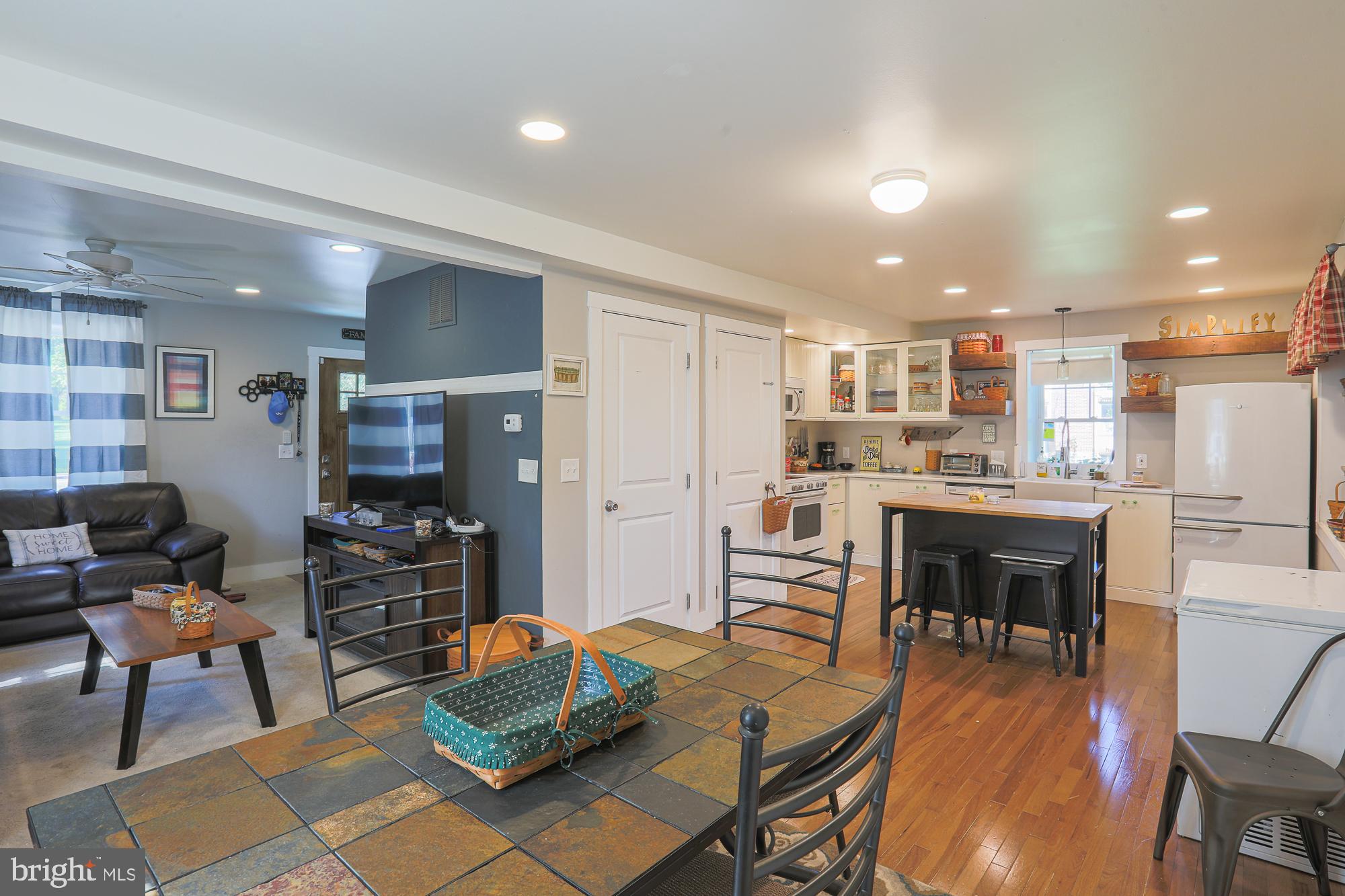 4604 East Joppa Road Perry Hall, MD 21128 - Photo 12 of 56 a living room with stainless steel appliances kitchen island granite countertop furniture and a dining table with wooden floor
