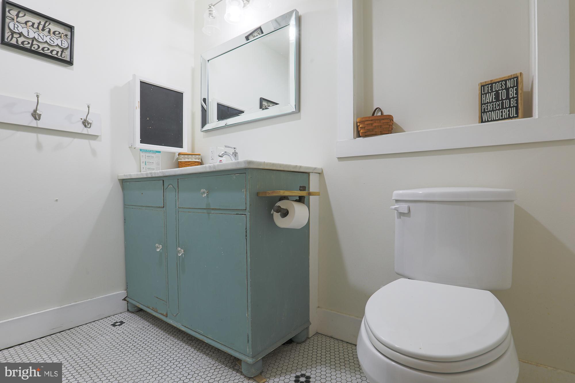 4604 East Joppa Road Perry Hall, MD 21128 - Photo 30 of 56 a bathroom with a toilet sink and mirror