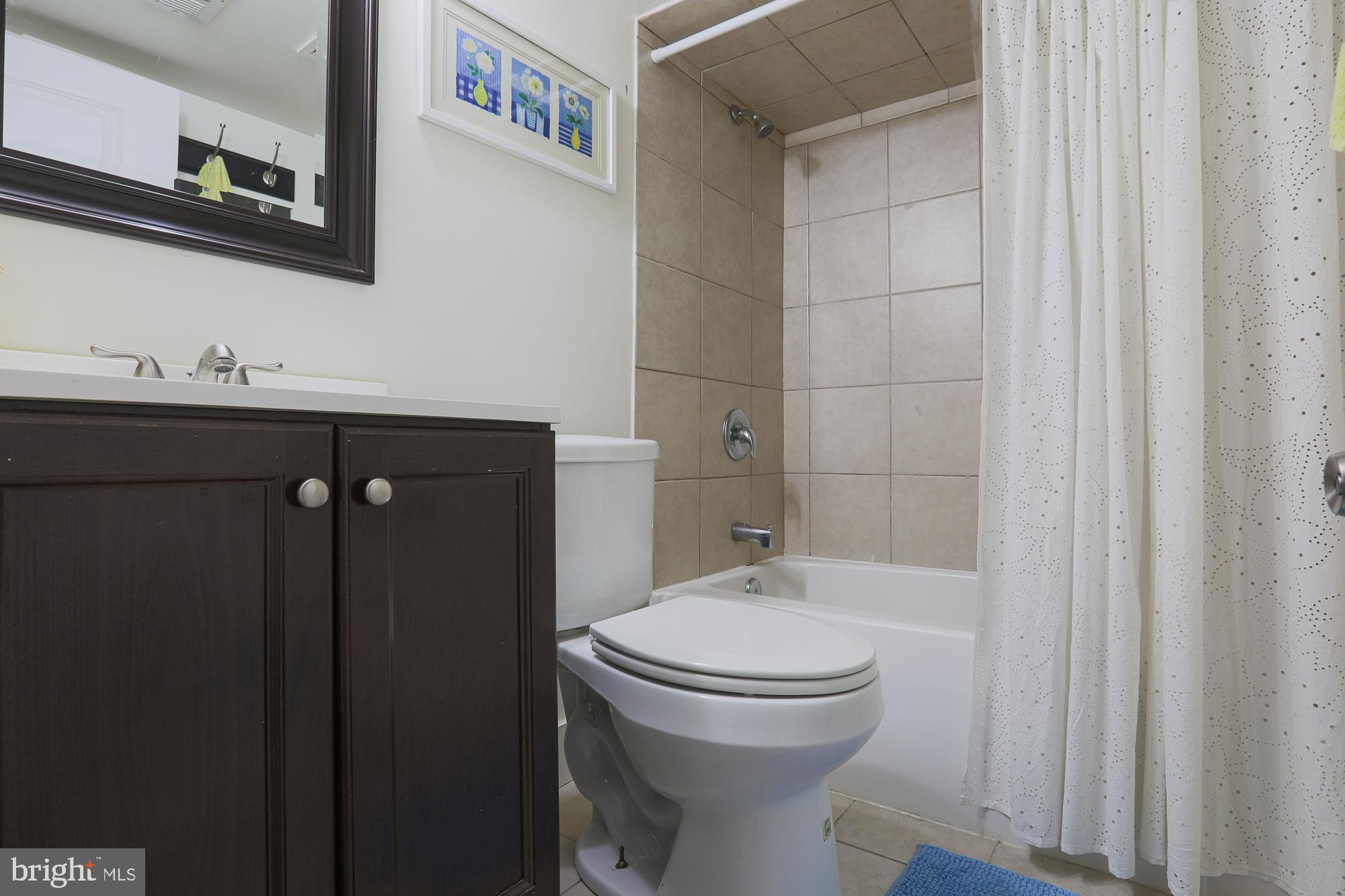 4604 East Joppa Road Perry Hall, MD 21128 - Photo 31 of 56 a bathroom with a sink a toilet and shower