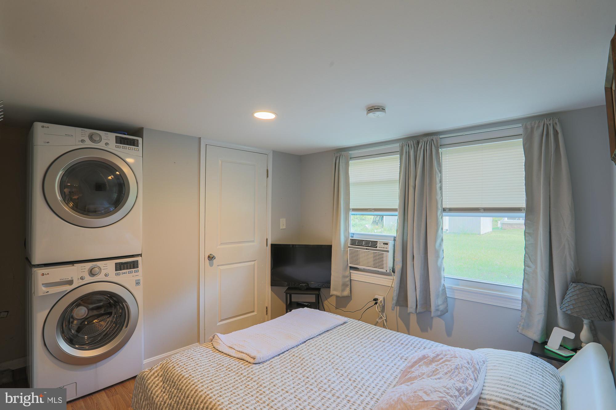 4604 East Joppa Road Perry Hall, MD 21128 - Photo 46 of 56 a bedroom with a bed and a washer dryer