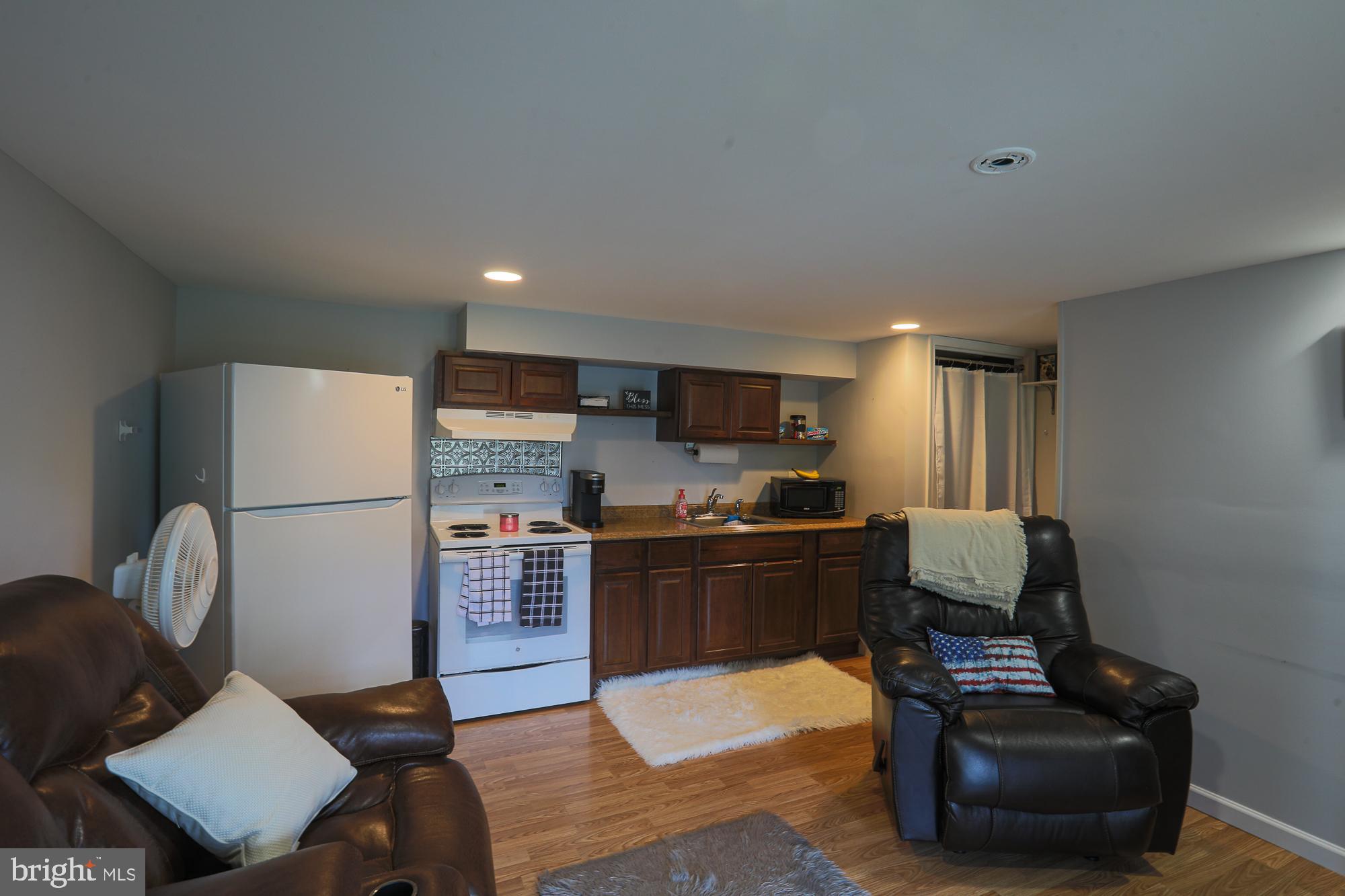 4604 East Joppa Road Perry Hall, MD 21128 - Photo 51 of 56 a living room with stainless steel appliances furniture a couch and a kitchen view