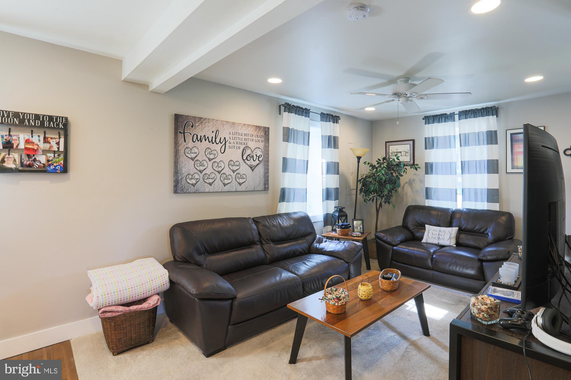 4604 East Joppa Road Perry Hall, MD 21128 - Photo 10 of 56 a living room with furniture and a flat screen tv
