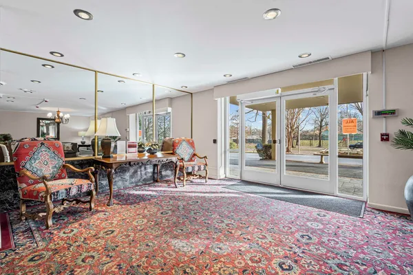 a very nice looking room with a large window and sitting area