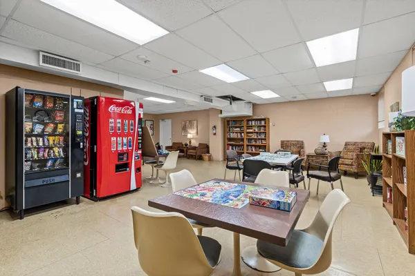 a living room with furniture and view of kitchen