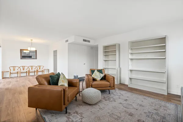 a living room with furniture and a lamp