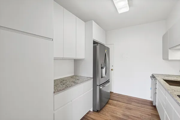 a kitchen with stainless steel appliances granite countertop a refrigerator and a stove