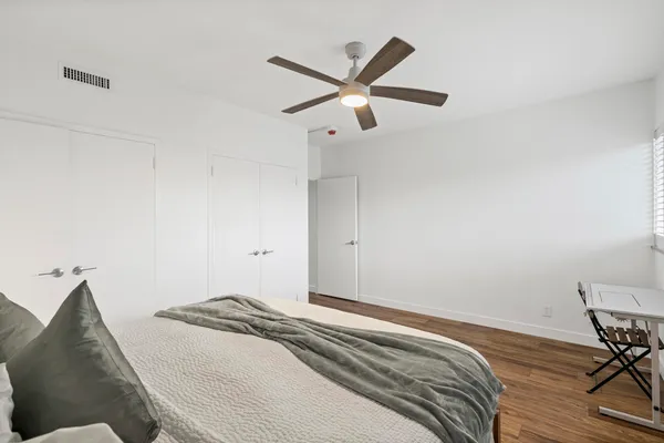a bedroom with a bed and cabinets