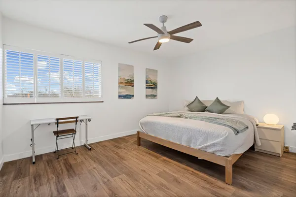 a spacious bedroom with a bed and a table