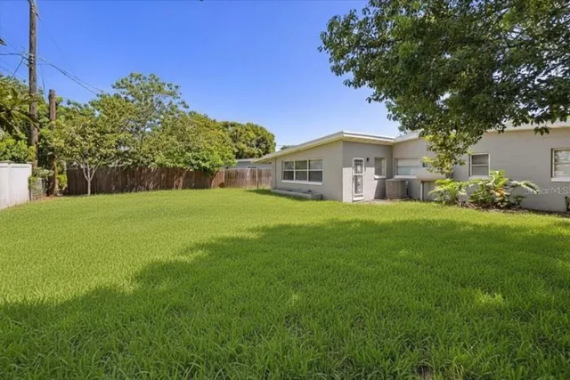 an aerial view of residential houses with outdoor space and street view