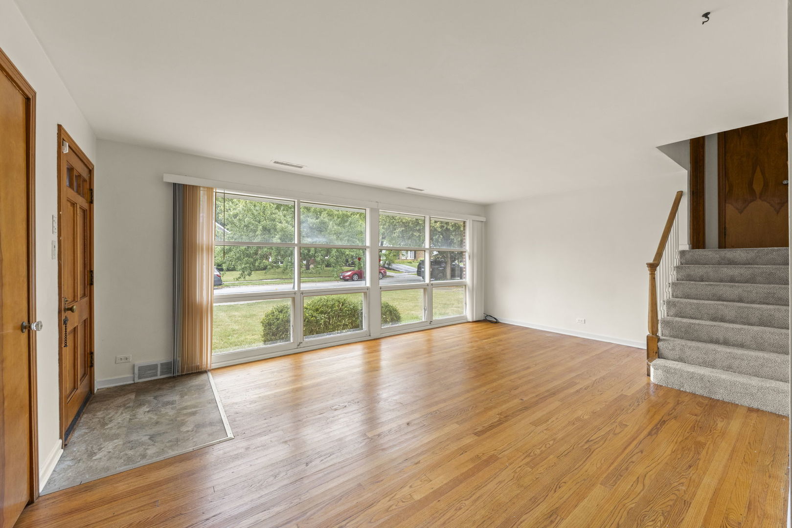 18508 Clyde Road Homewood, IL 60430 - Photo 4 of 20 a view of an empty room with wooden floor and a window