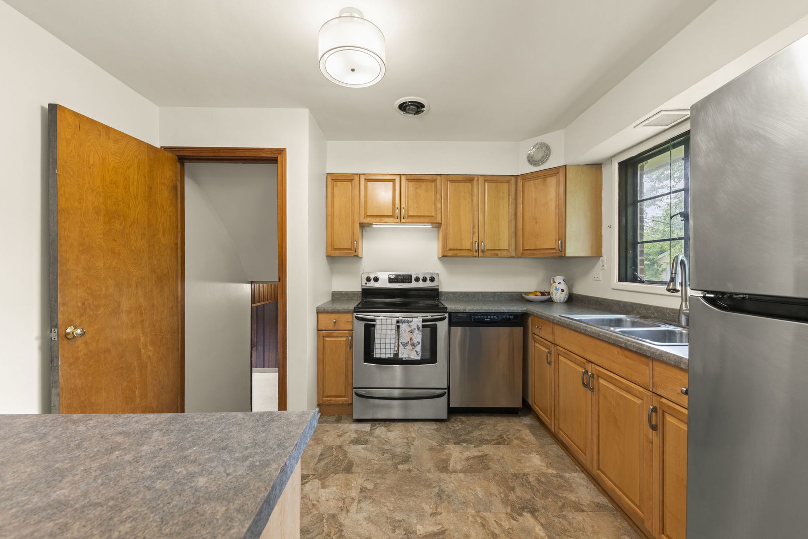 18508 Clyde Road Homewood, IL 60430 - Photo 6 of 20 a kitchen with a stove a sink and a refrigerator