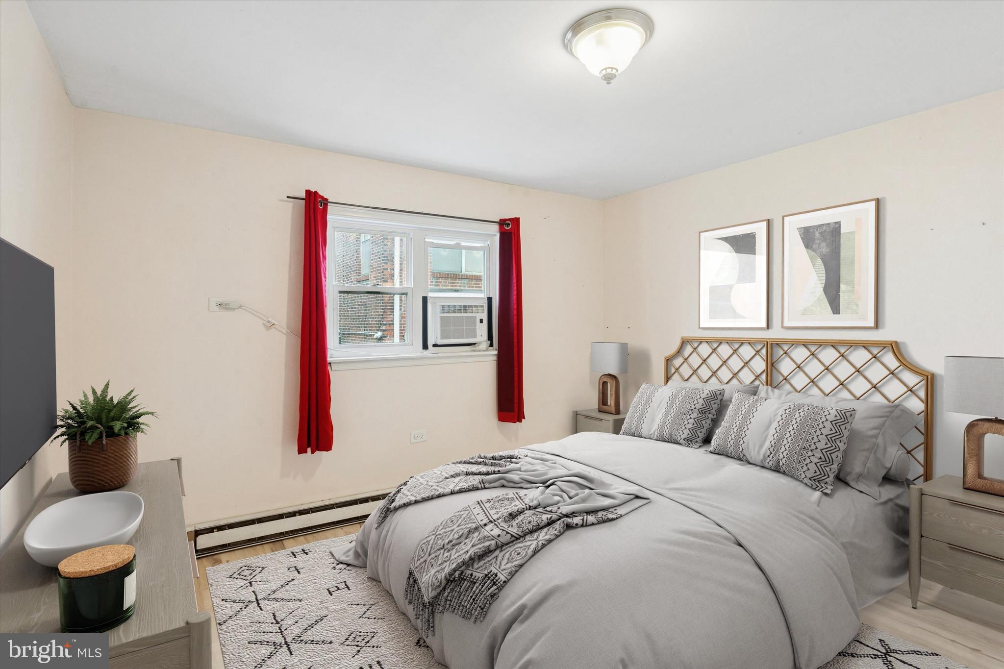 933 Cantrell Street Philadelphia, PA 19148 - Photo 13 of 25 a bedroom with a bed and a potted plant