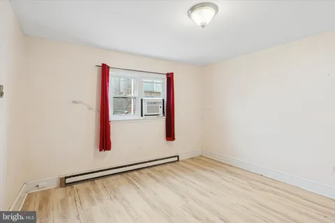 a view of a room with wooden floor and white walls