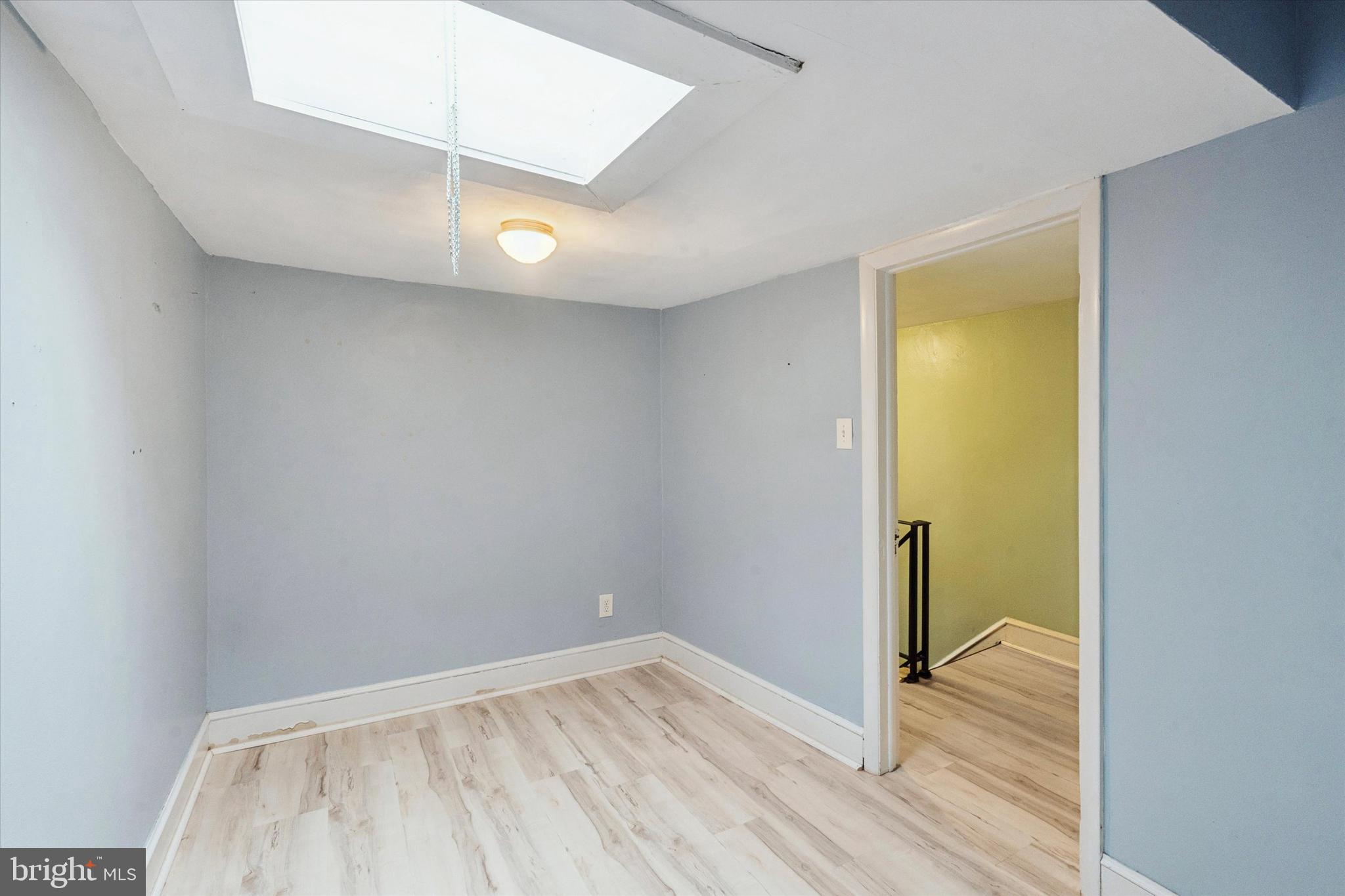 933 Cantrell Street Philadelphia, PA 19148 - Photo 19 of 25 a view of an empty room with wooden floor and a window