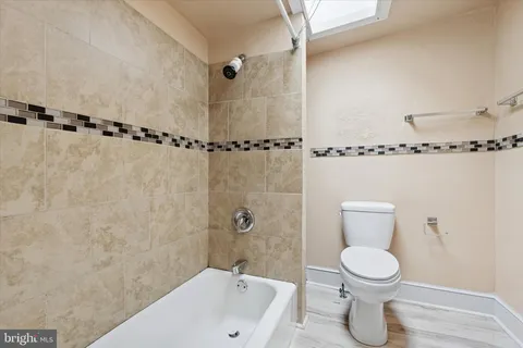 a bathroom with a toilet a sink and shower