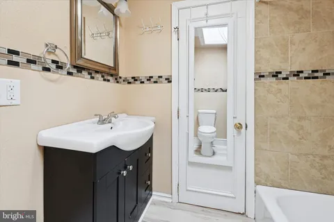 a bathroom with a sink a mirror and shower