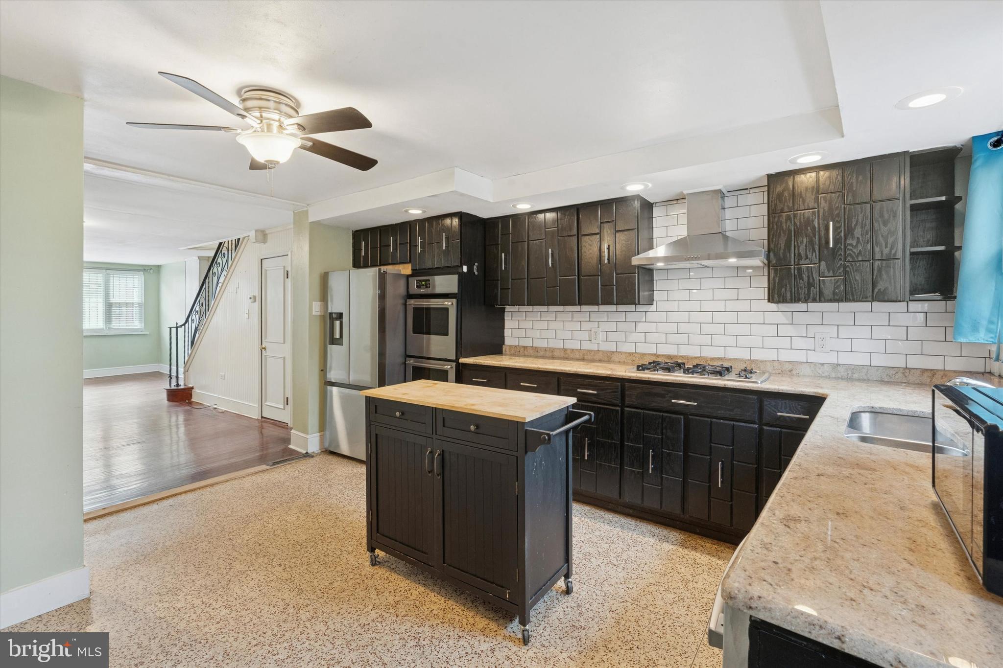 933 Cantrell Street Philadelphia, PA 19148 - Photo 7 of 25 a kitchen with stainless steel appliances granite countertop a sink and a stove