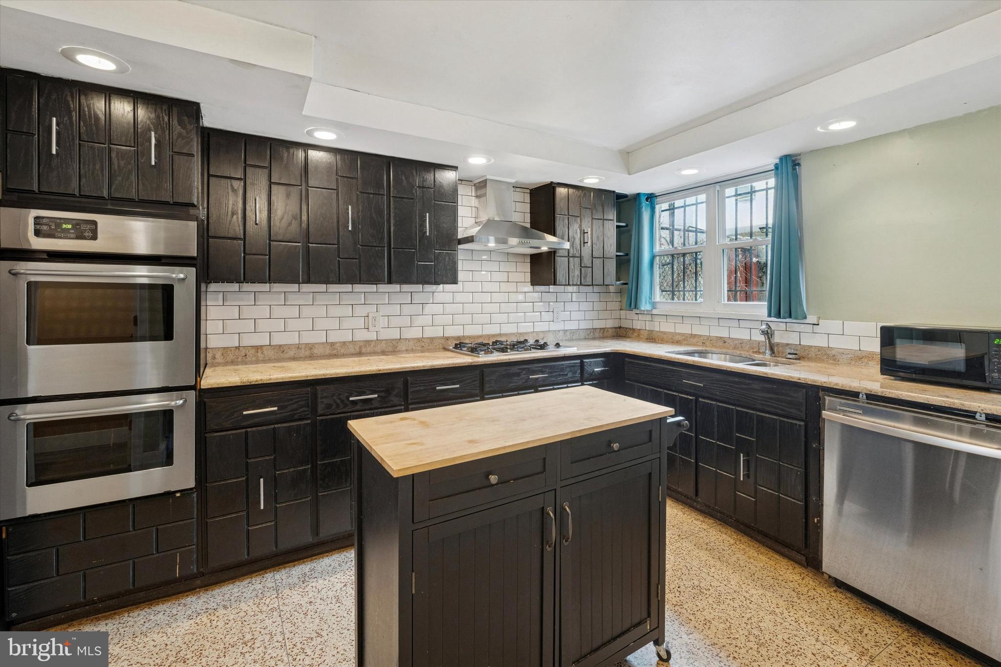 933 Cantrell Street Philadelphia, PA 19148 - Photo 8 of 25 a kitchen with a sink stove and microwave