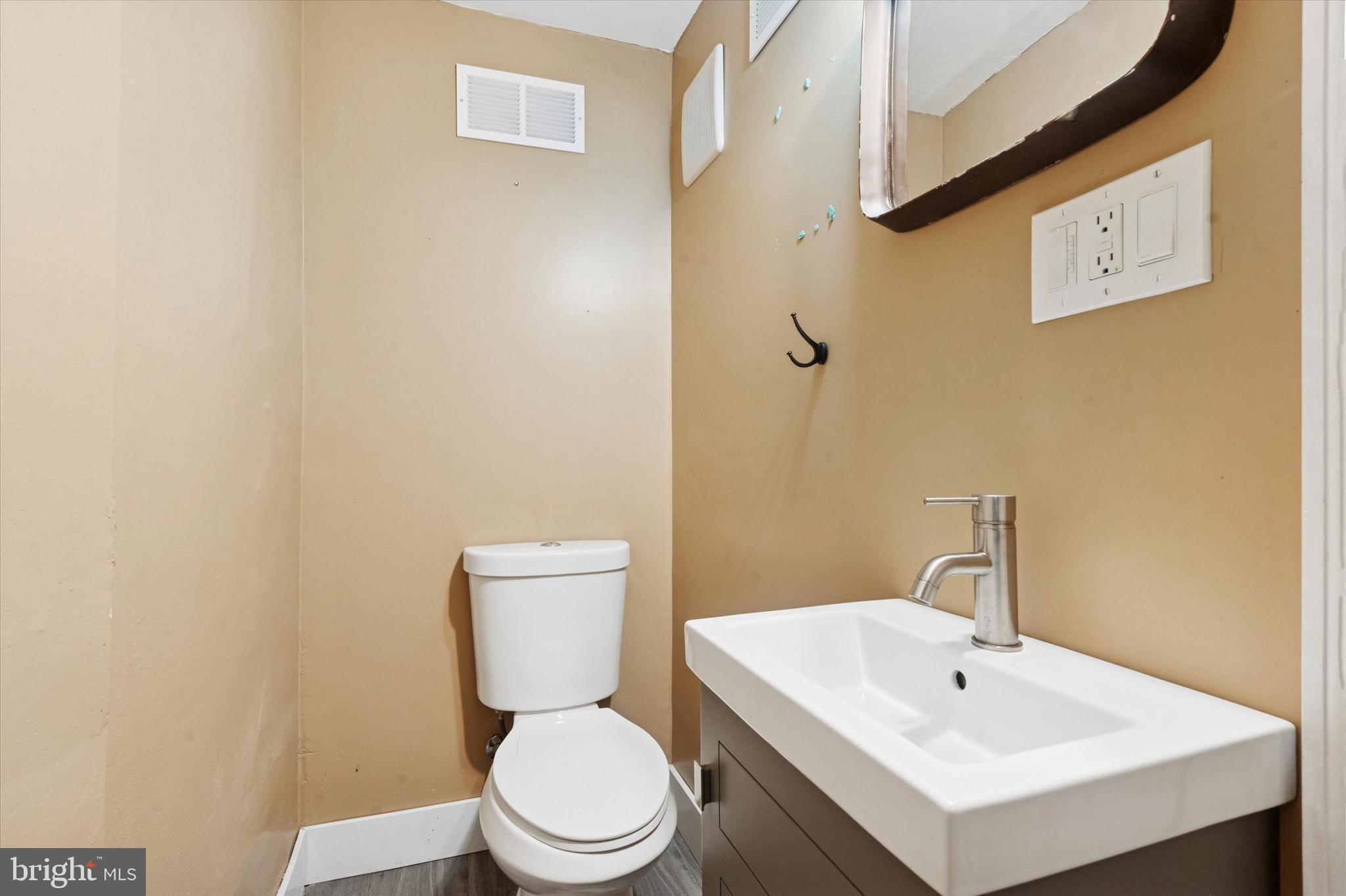 933 Cantrell Street Philadelphia, PA 19148 - Photo 10 of 25 a white toilet sitting next to a bathroom sink