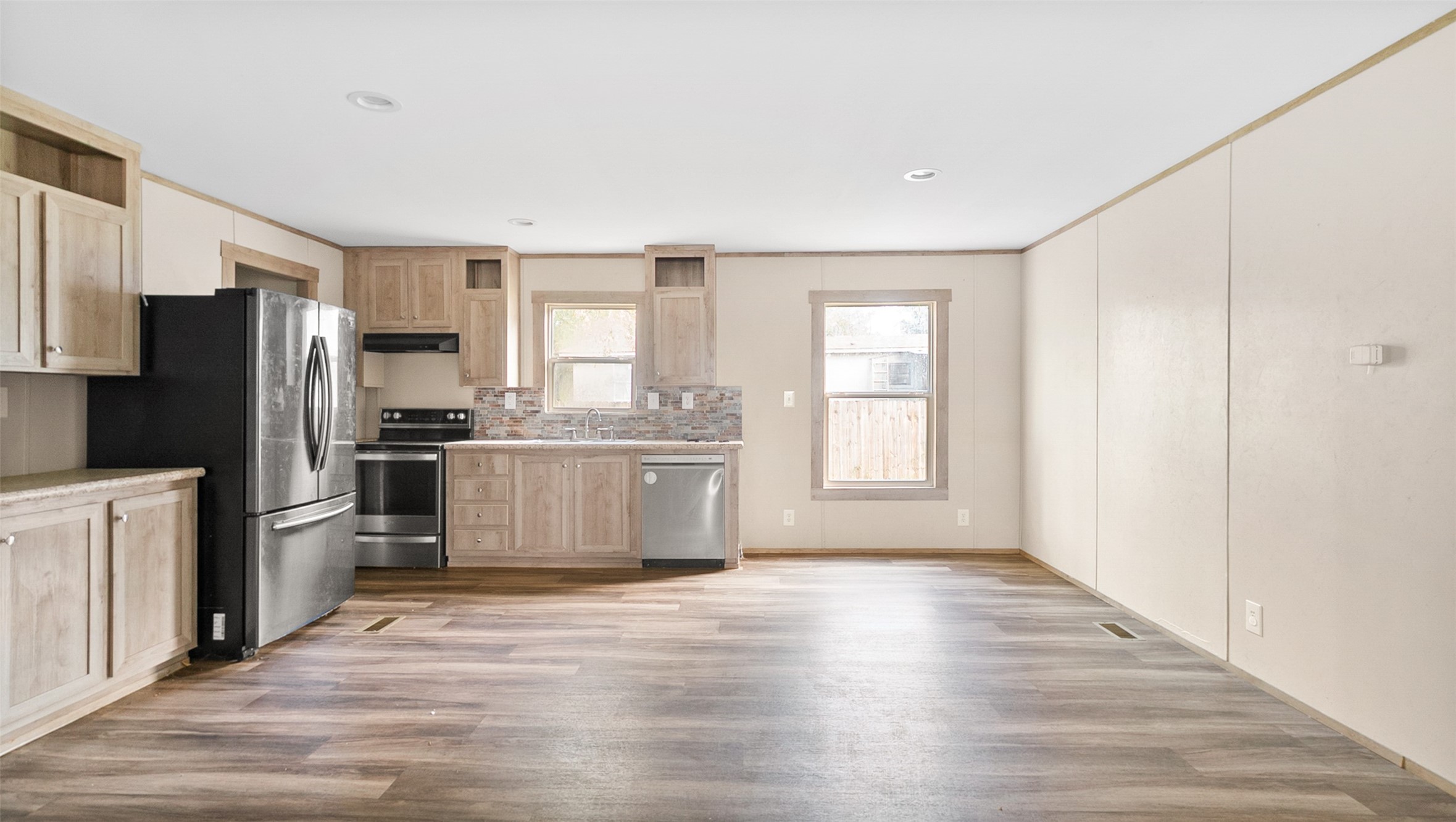 10499 Highway 156 Coldspring, TX 77331 - Photo 11 of 45 a kitchen with stainless steel appliances a refrigerator and wooden floor