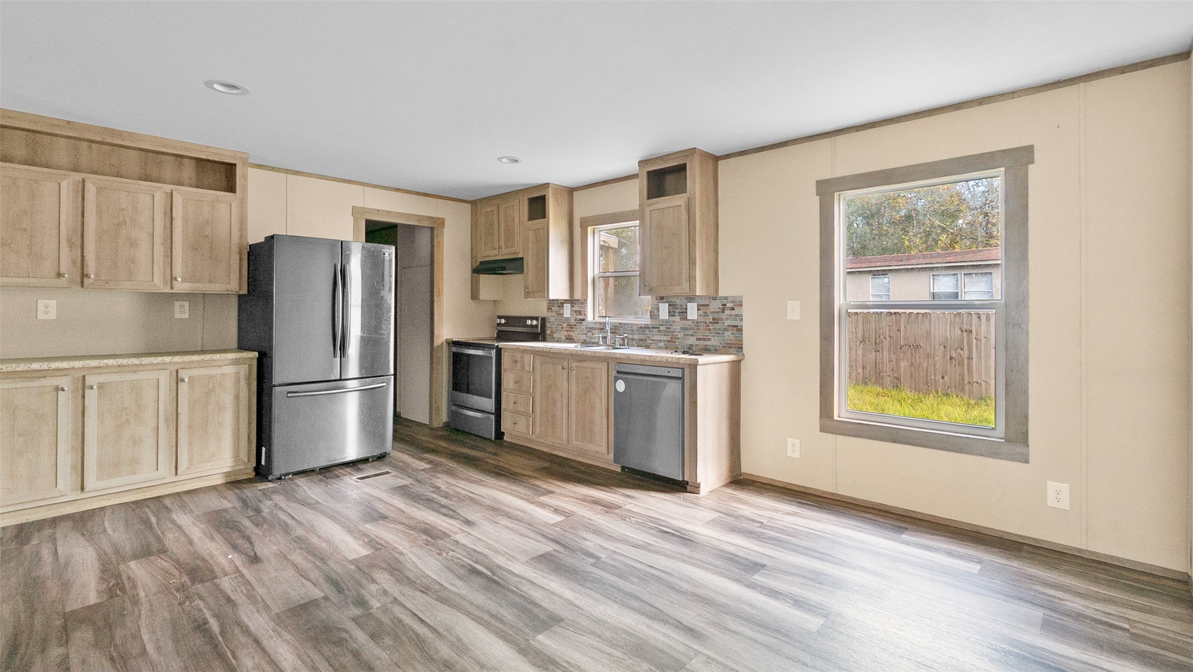 10499 Highway 156 Coldspring, TX 77331 - Photo 12 of 45 a kitchen with stainless steel appliances granite countertop a refrigerator and a stove top oven