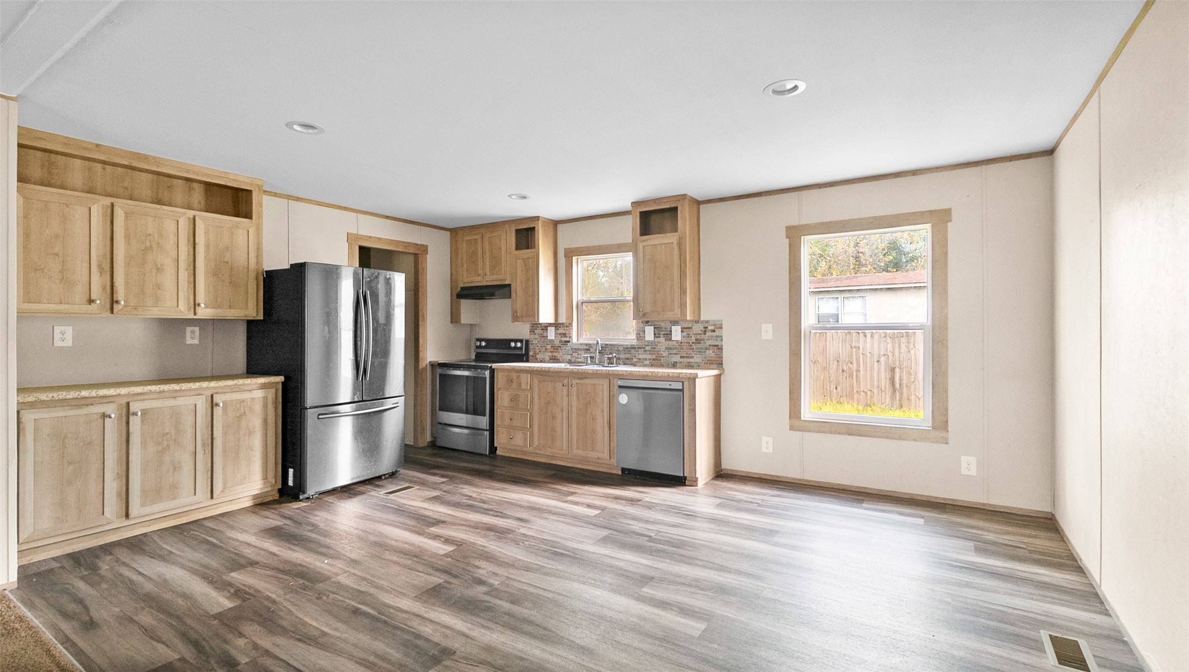 10499 Highway 156 Coldspring, TX 77331 - Photo 13 of 45 a kitchen with stainless steel appliances a refrigerator and wooden cabinets