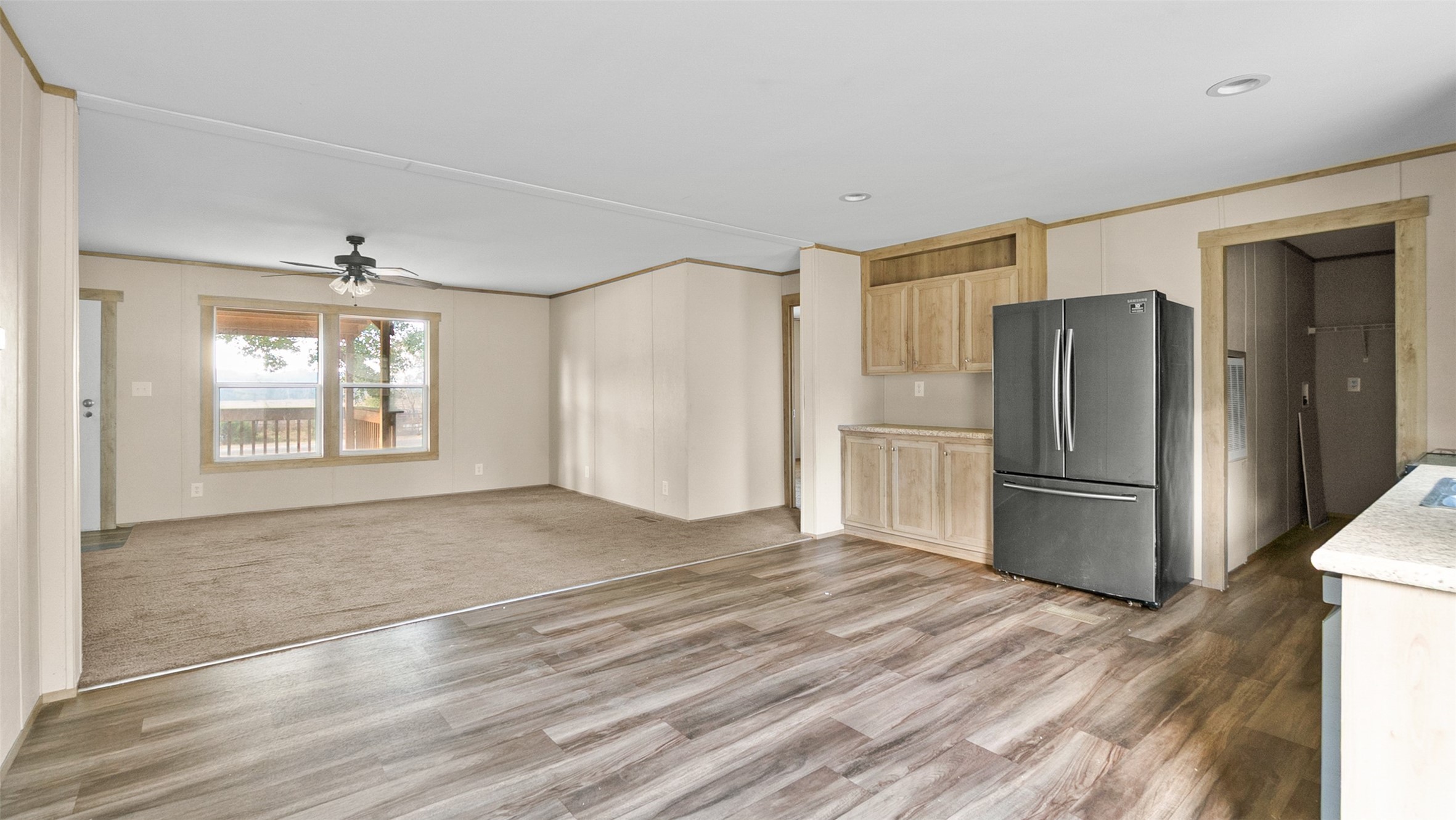 10499 Highway 156 Coldspring, TX 77331 - Photo 15 of 45 a view of a kitchen with a sink refrigerator and wooden floor