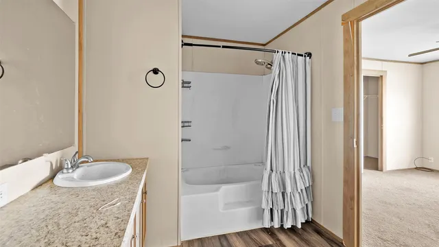 a bathroom with a granite countertop sink mirror bathtub and shower
