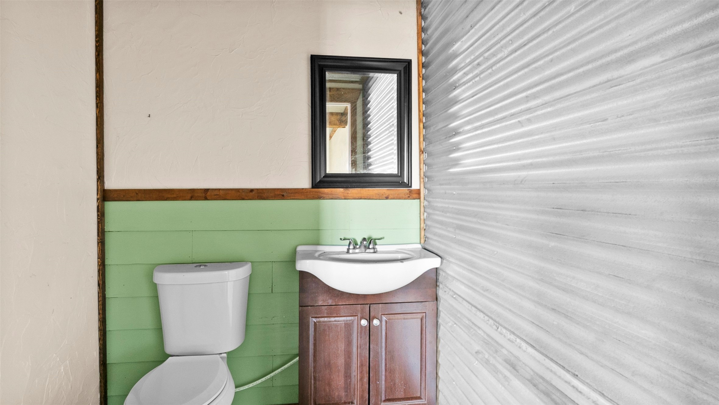 10499 Highway 156 Coldspring, TX 77331 - Photo 36 of 45 a bathroom with a toilet sink and mirror