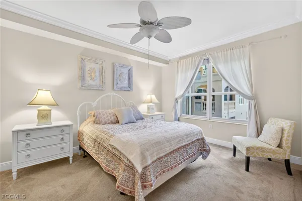 a bedroom with a bed a lamp and a chandelier