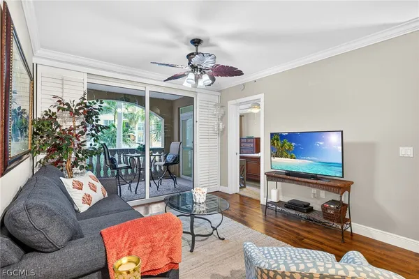 a living room with furniture a chandelier and a table