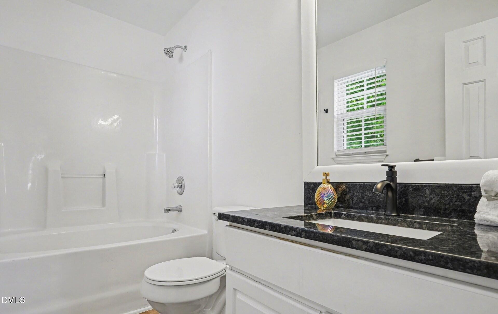 1237 Swingline Way Raleigh, NC 27610 - Photo 8 of 14 a bath room with a sink and a toilet