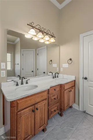 a bathroom with double sink and a mirror