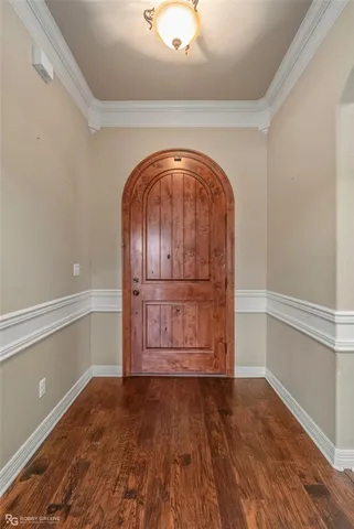 a view of a room with wooden floor