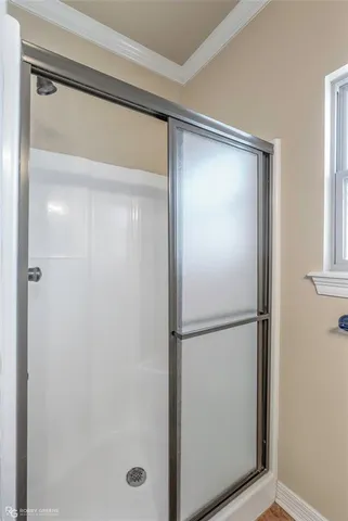 a bathroom with a glass shower door