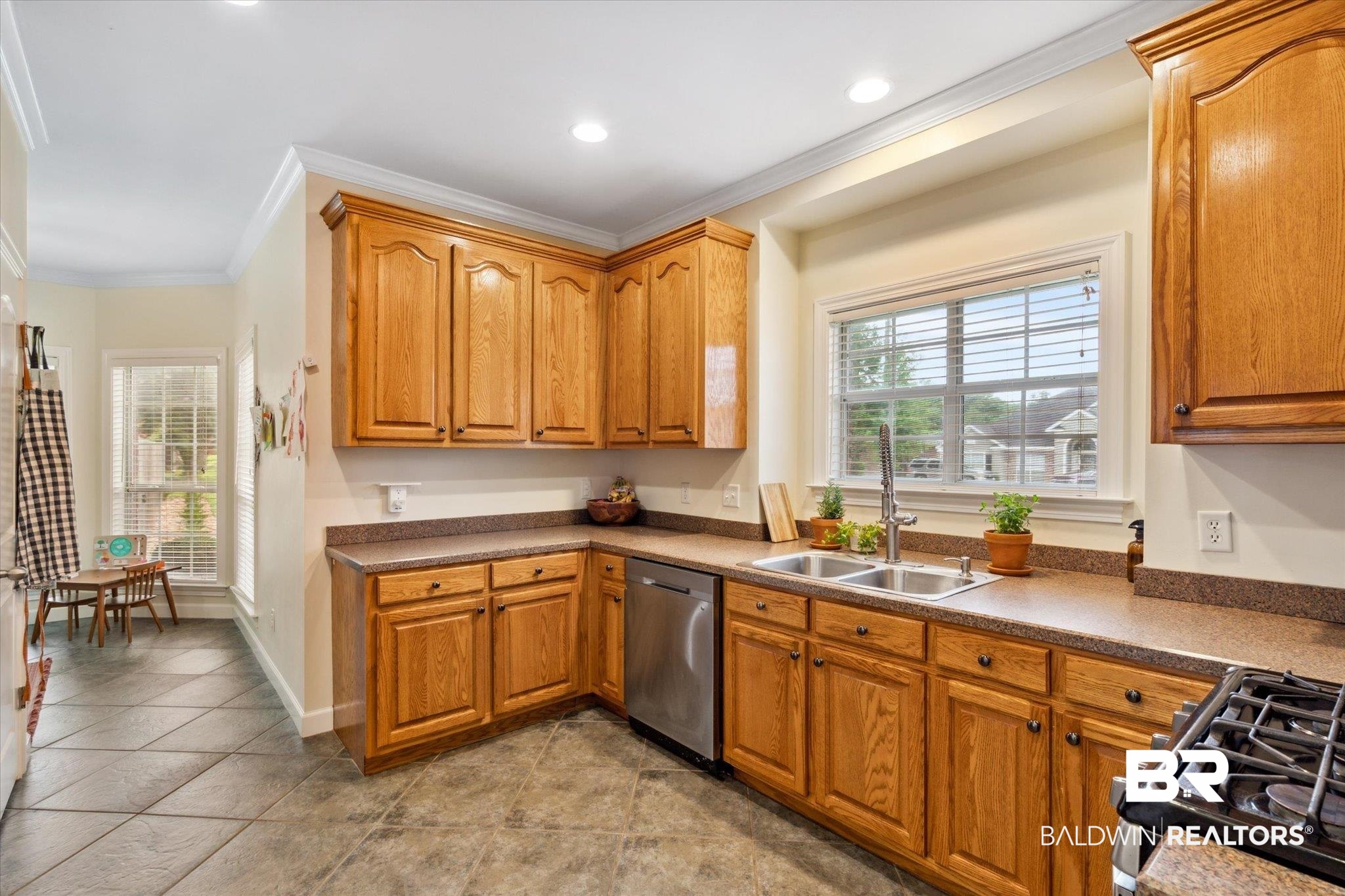 1561 William Dunn Way Mobile, AL 36695 - Photo 7 of 28 Kitchen featuring sink, dishwasher, a wealth of natural light, and light tile patterned floors