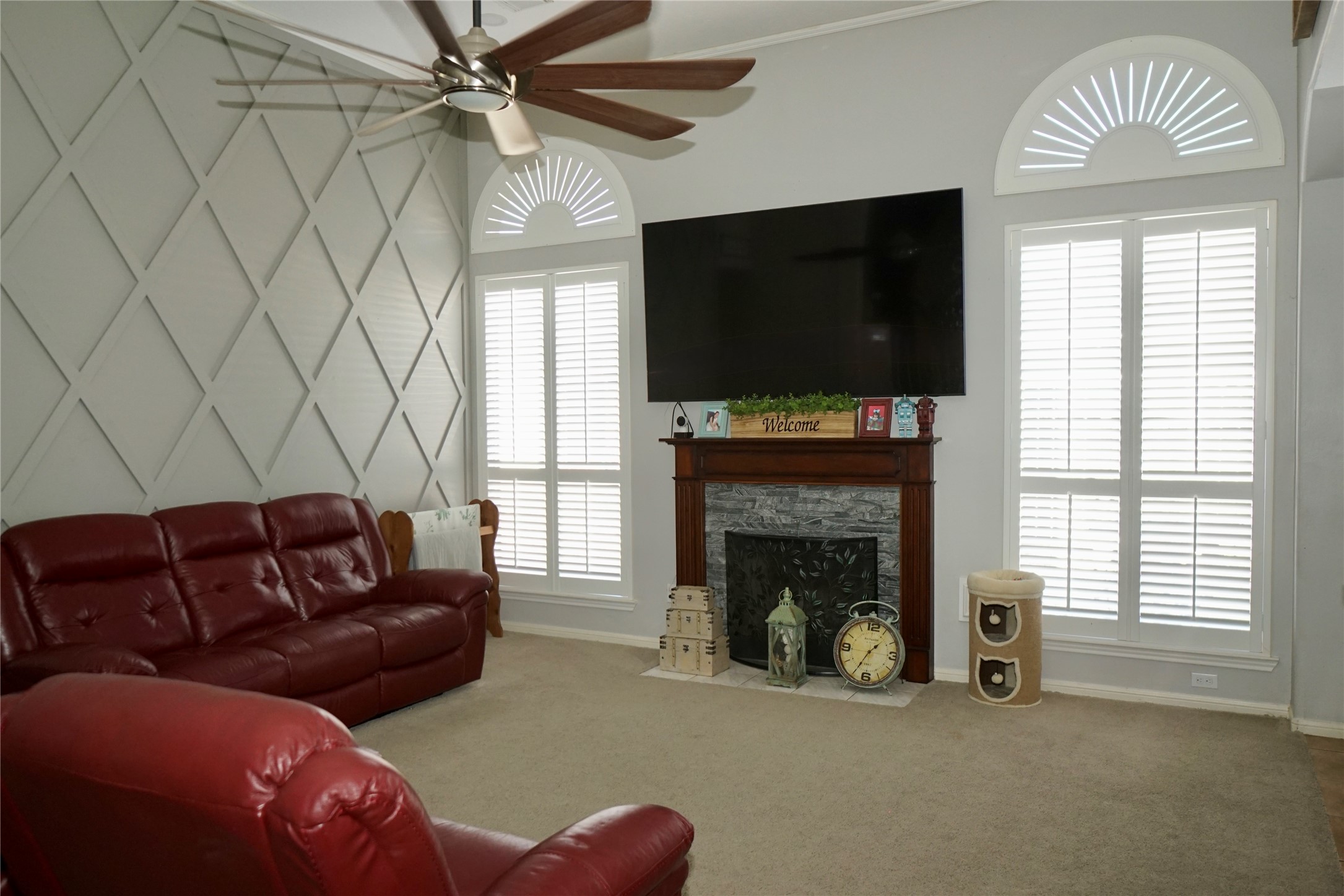 1806 Shadow Haven Court Fresno, TX 77545 - Photo 3 of 22 a living room with furniture a flat screen tv and a fireplace