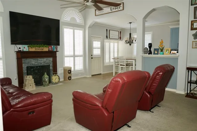 a living room with furniture a flat screen tv and a fireplace