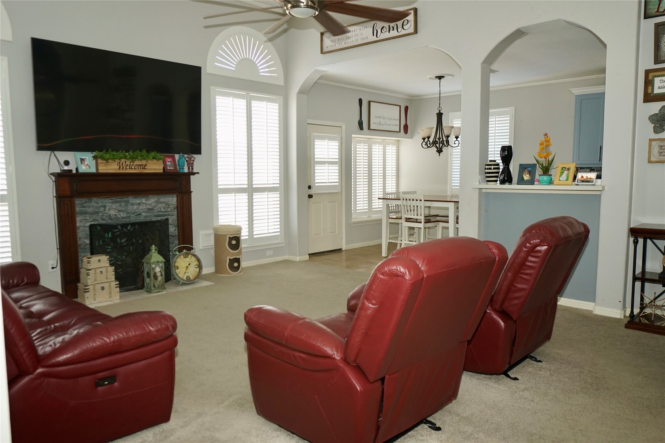 1806 Shadow Haven Court Fresno, TX 77545 - Photo 4 of 22 a living room with furniture a flat screen tv and a fireplace