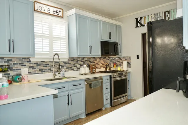 a kitchen with a sink stove and refrigerator