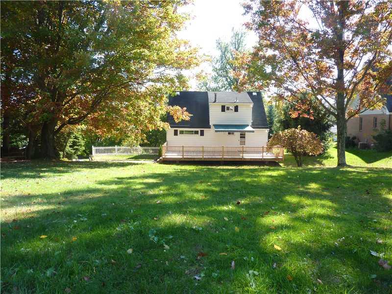 952 Harper Road Crescent, PA 15046 - Photo 16 of 18 Exterior Back. SPACIOUS REAR YARD SHOWING DECK AND RETRACTABLE AWNING.