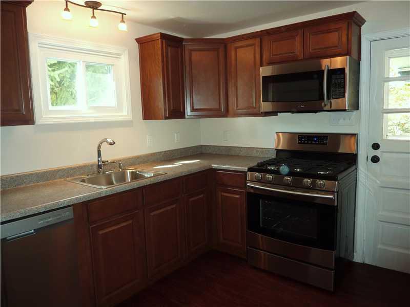 952 Harper Road Crescent, PA 15046 - Photo 3 of 18 Kitchen. EVERYTHING IS NEW* NEW WINDOW, RICH WOOD CABINETRY, COUNTER TOPS, CEILING FAN, FLOORING STAINLESS STEEL DISHWASHER, REFRIGERATOR, GAS STOVE AND MICROWAVE.