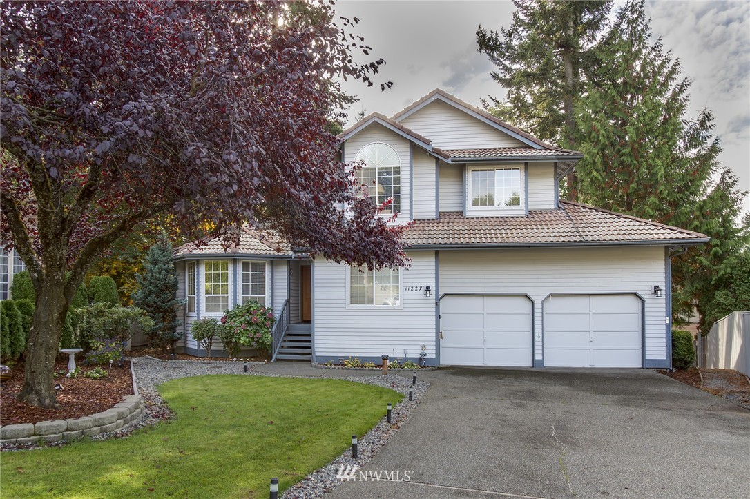 11227 Southeast 183rd Street Renton, WA 98055 - Photo 1 of 1 a front view of a house with a garden and yard