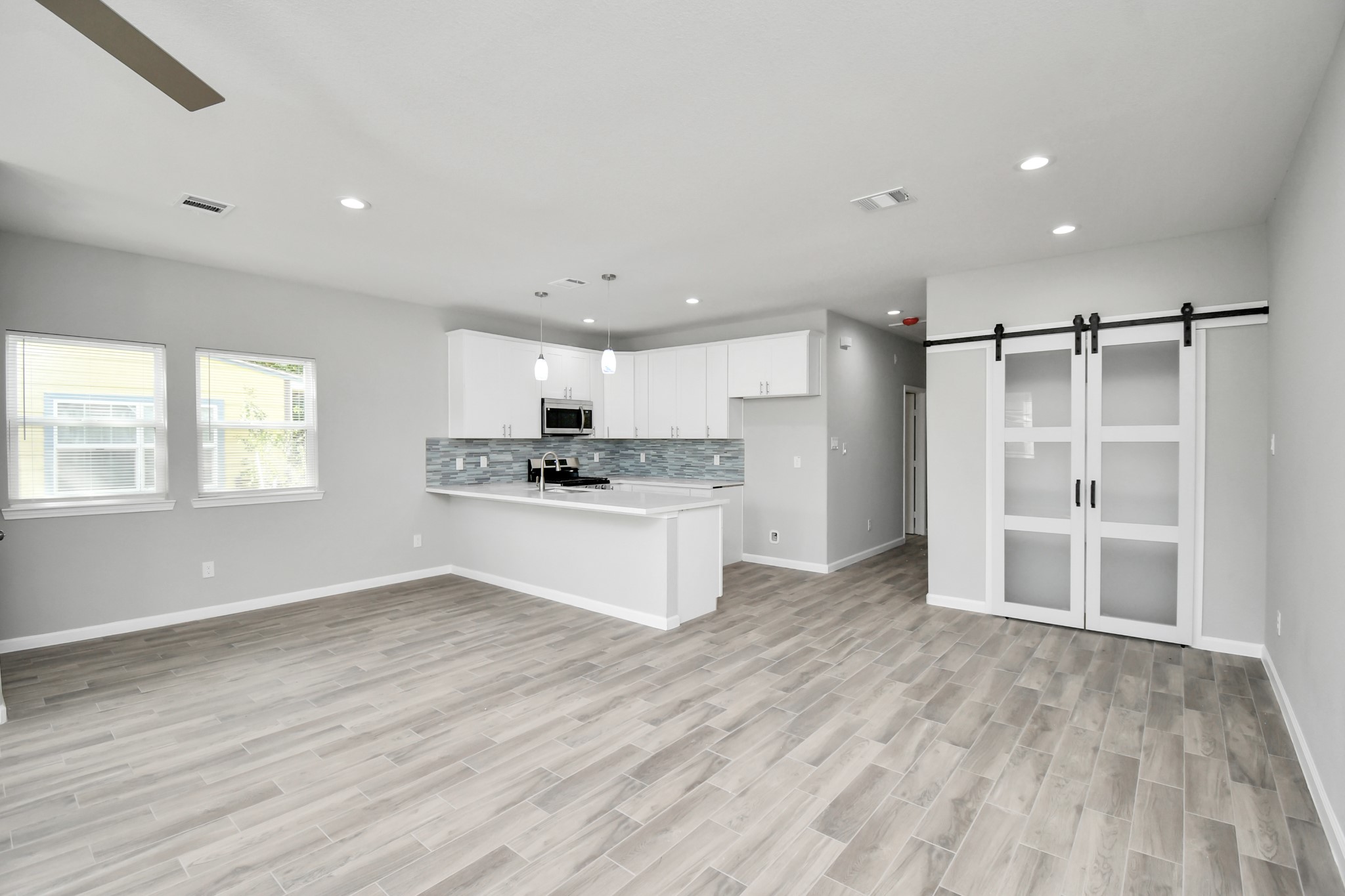 5941 Southlea Street Houston, TX 77033 - Photo 11 of 31 a kitchen with a refrigerator and window