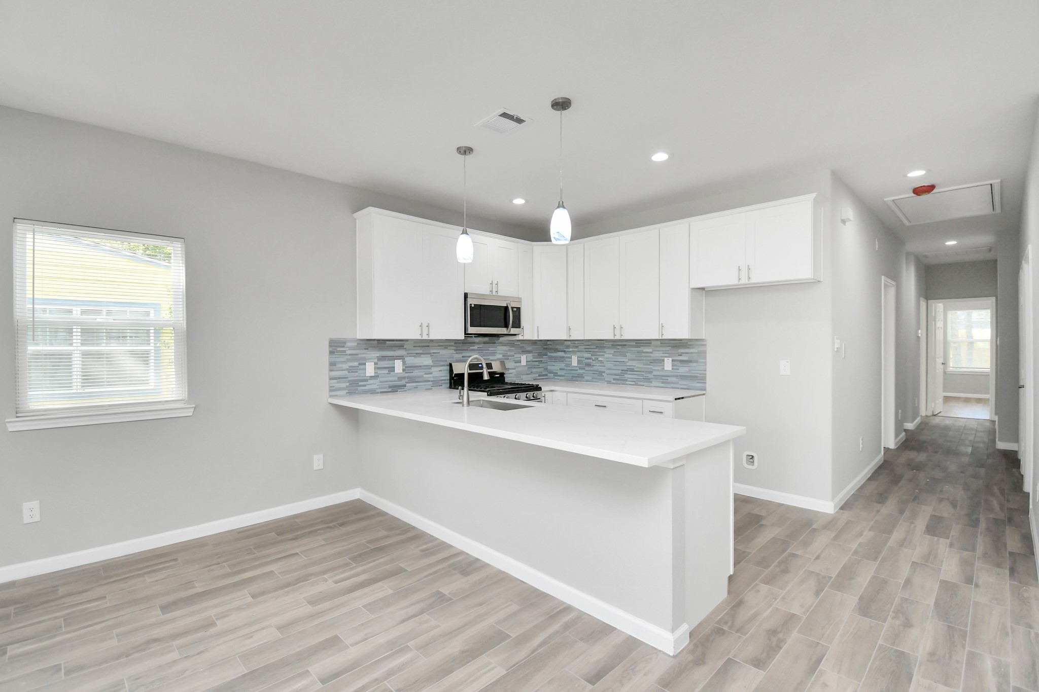 5941 Southlea Street Houston, TX 77033 - Photo 14 of 31 a kitchen with stainless steel appliances granite countertop a sink stove and refrigerator