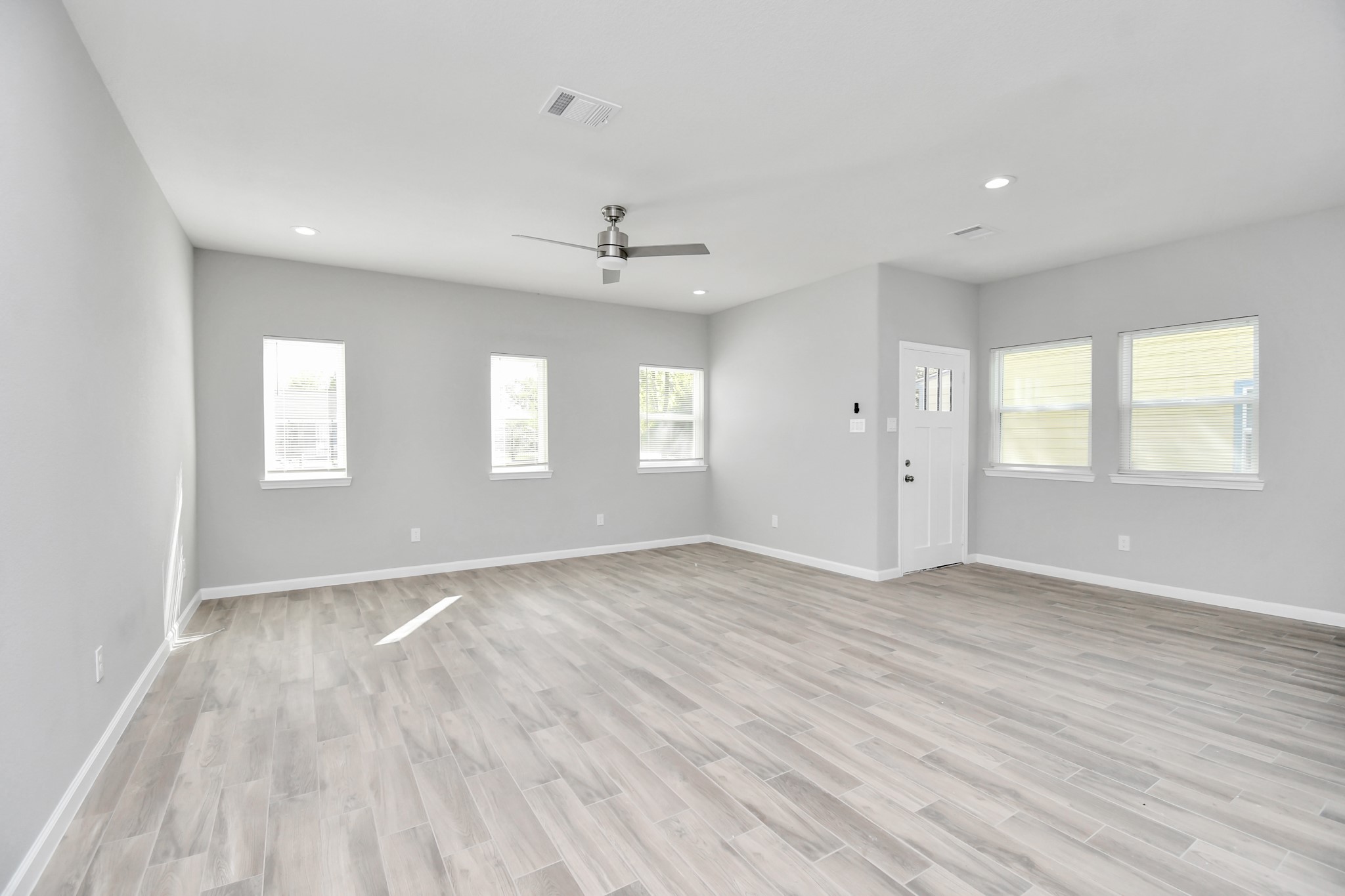 5941 Southlea Street Houston, TX 77033 - Photo 8 of 31 a view of an empty room with wooden floor and a window