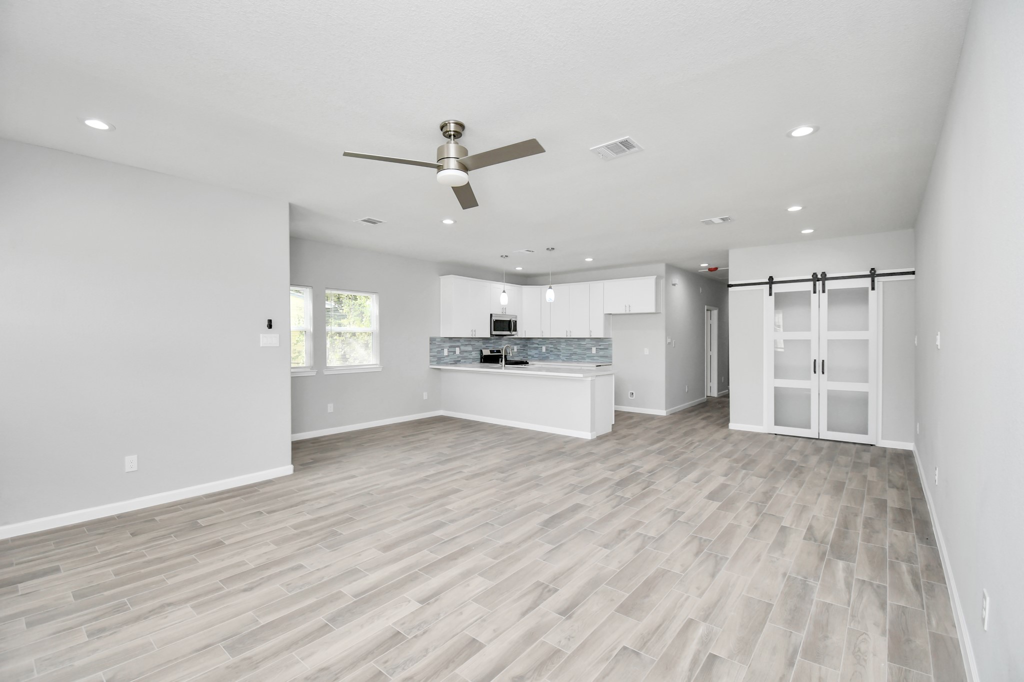 5941 Southlea Street Houston, TX 77033 - Photo 9 of 31 a view of a kitchen with a sink and dishwasher a refrigerator with wooden floor