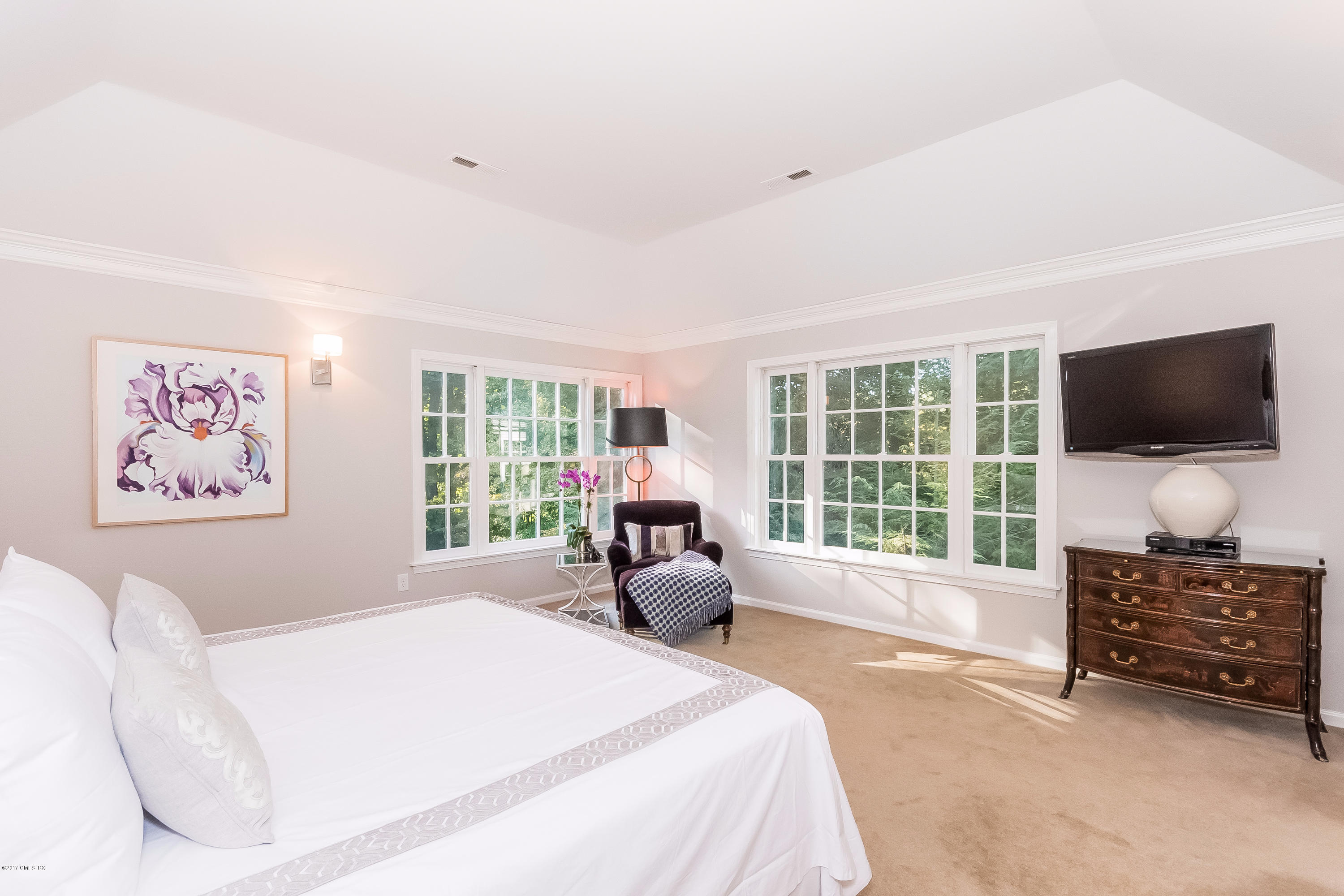 85 Perkins Road Greenwich, CT 06830 - Photo 18 of 36 a spacious bedroom with a bed and glass wall couch